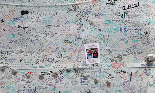 A woman kneels beside a message wall near the scene of the fire which destroyed the Grenfell Tower block, in north Kensington, West London, Britain June 15, 2017. REUTERS/Stefan Wermuth TPX IMAGES OF THE DAY