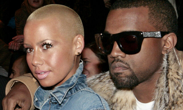 U.S. performer Kanye West, right, and Amber Rose, left, attend Belgian designer Kris Van Assche's collection for Dior, during the presentation of his Men's Fall-Winter 2010-2011 collection, in Paris, Saturday, Jan. 23, 2010. (AP Photo/Jacques Brinon)